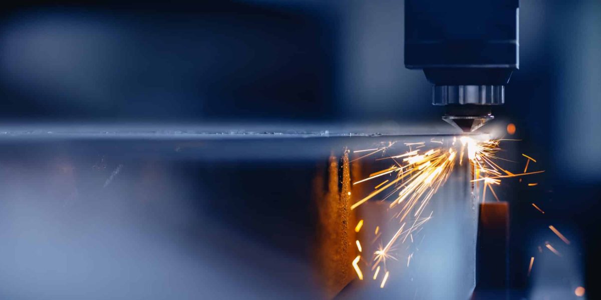 Blue color Laser CNC cut of metal with light spark, technology modern industrial.